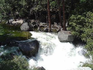 rapids flowing between boulders